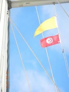 The yellow 'Q' flag denoting new arrival from another country with the Tunisian courtesy flag underneath