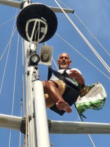Walter up the mast in the bosuns chair. The birds had flown off at his approach - can't blame them for that!