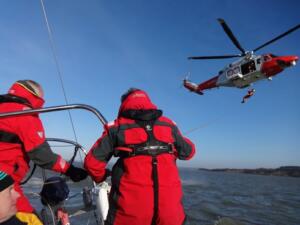 m_Helicopter preparing to winch crew onto Hejira's deck
